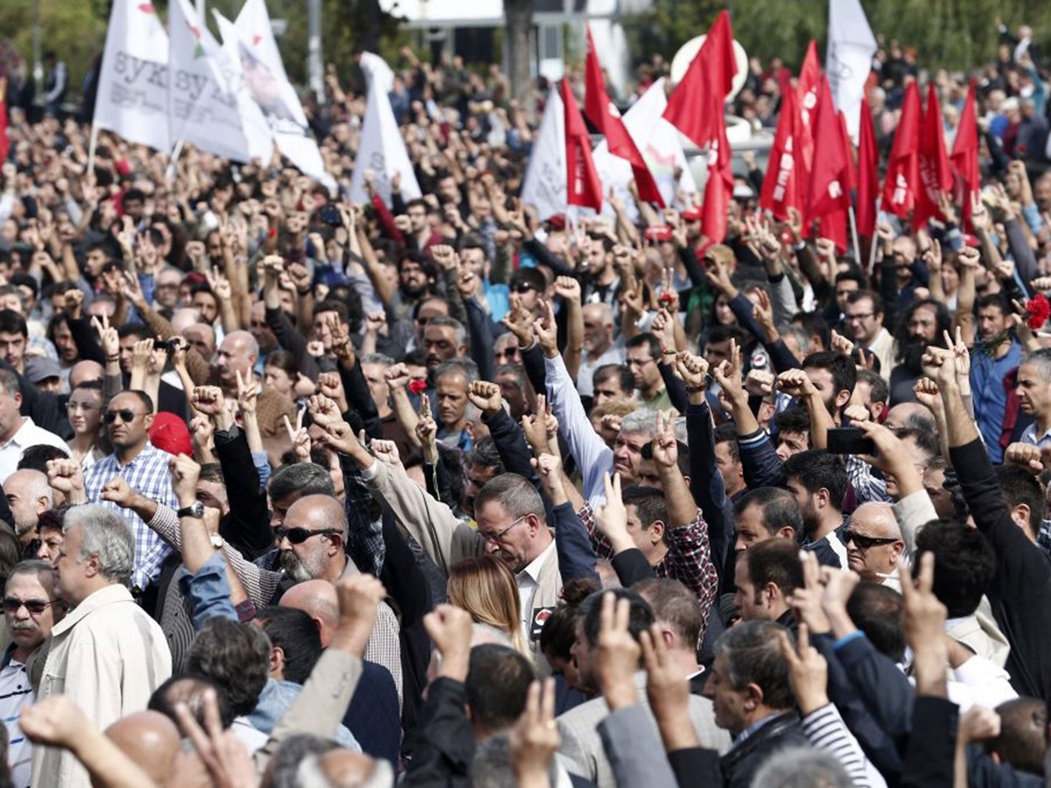 People raise their fists as a salute for victims during a demonstration on the day after a twin blast in Ankara that killed at least 128 people, in Ankara, Turkey, 11 October 2015.