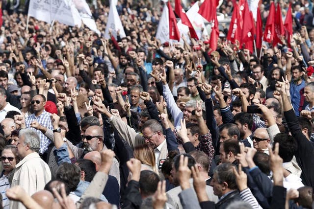 People raise their fists as a salute for victims during a demonstration on the day after a twin blast in Ankara that killed at least 128 people, in Ankara, Turkey, 11 October 2015.