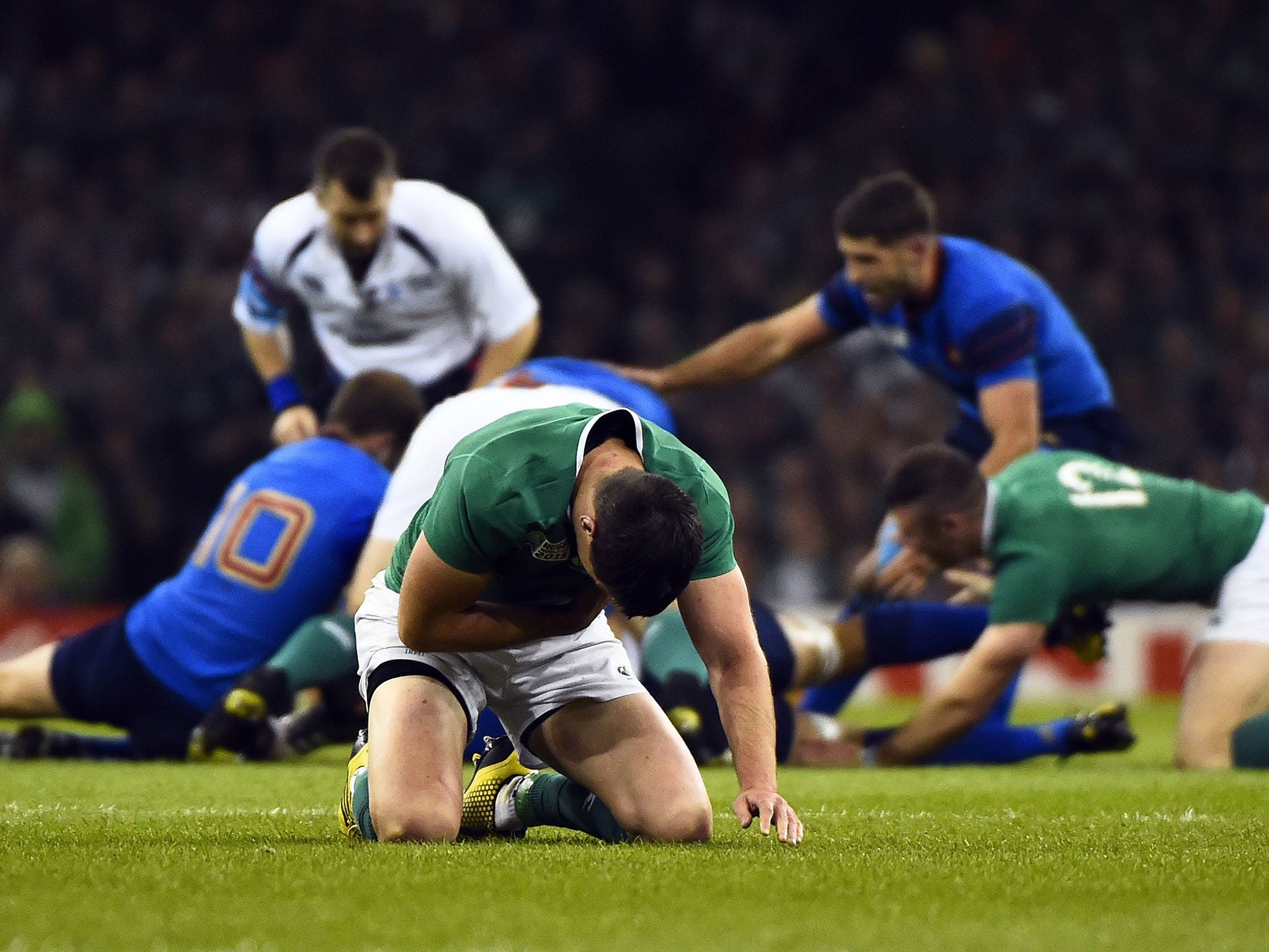 Jonathan Sexton holds his chest after being tackled by Louis Picamoles