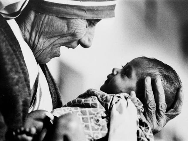 Mother Teresa cradles an armless baby girl at her order's orphanage in what was then known as Calcutta, India, 1978