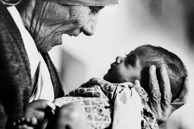 Mother Teresa cradles an armless baby girl at her order's orphanage in what was then known as Calcutta, India, 1978