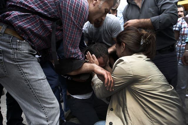A relative of a victim of Saturday's bombing attack reacts, outside a hospital's morgue