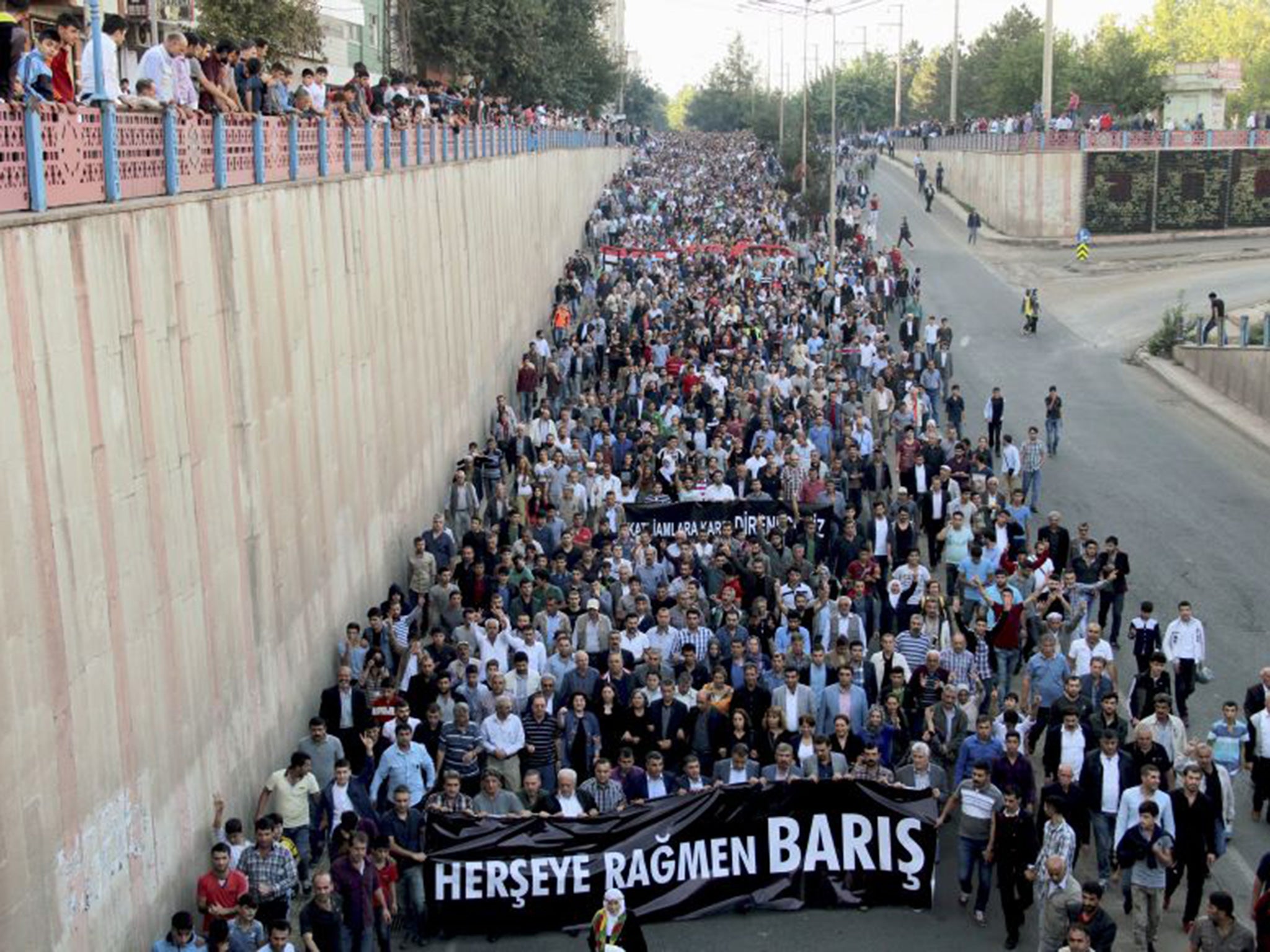 People march to protest the double suicide bombing in Ankara that killed up to 128 people in Diyarbakir, eastern Turkey