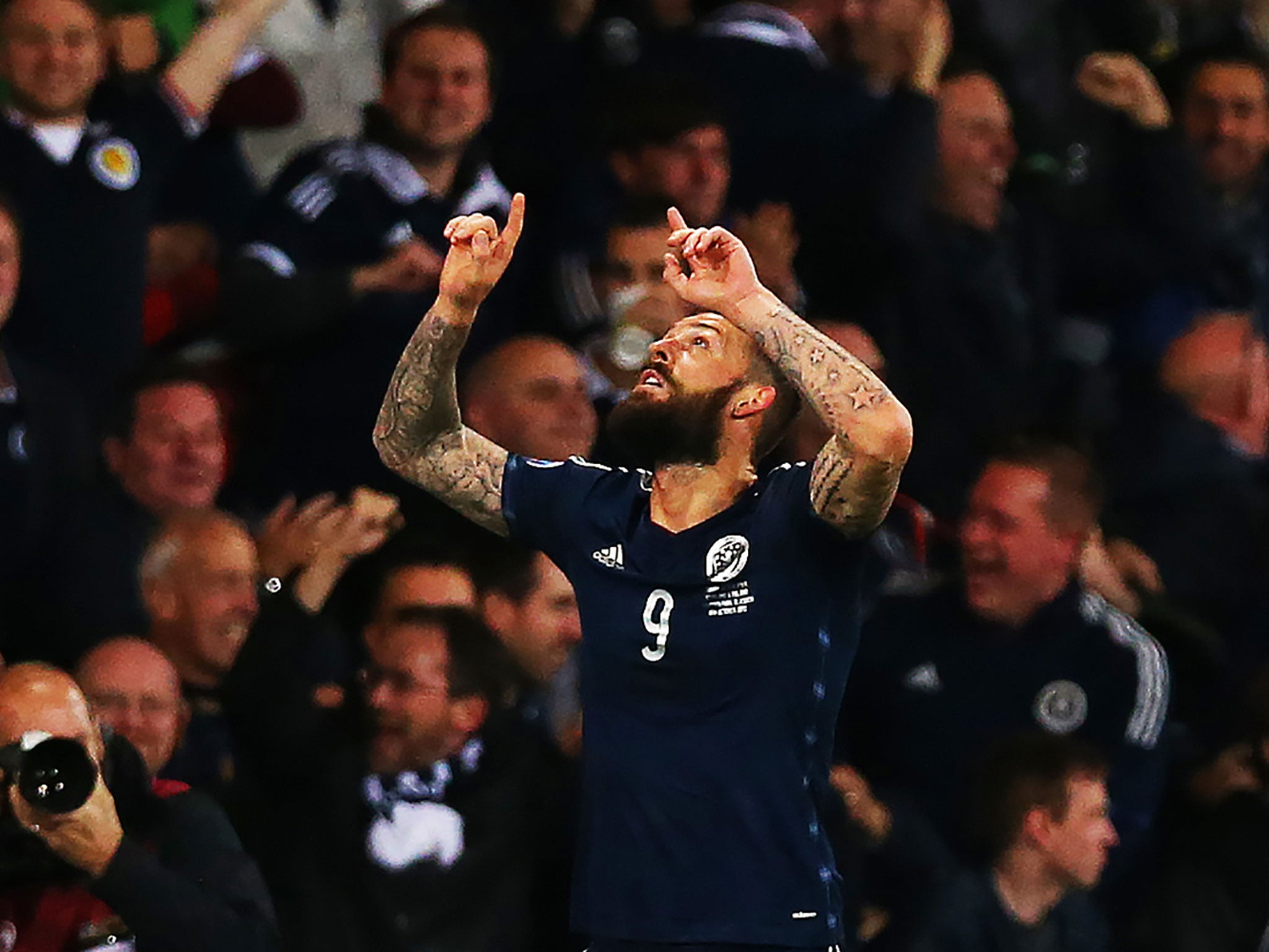 Steven Fletcher points to the sky in celebration of one of his three goals against Gibraltar