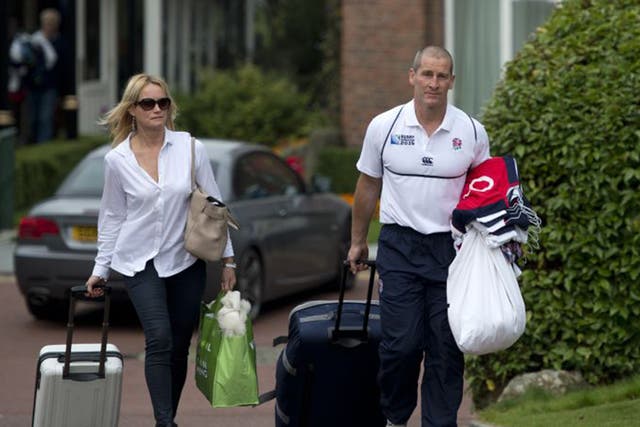 England coach Stuart Lancaster leaves the team hotel in Worsley yesterday with his wife Nina