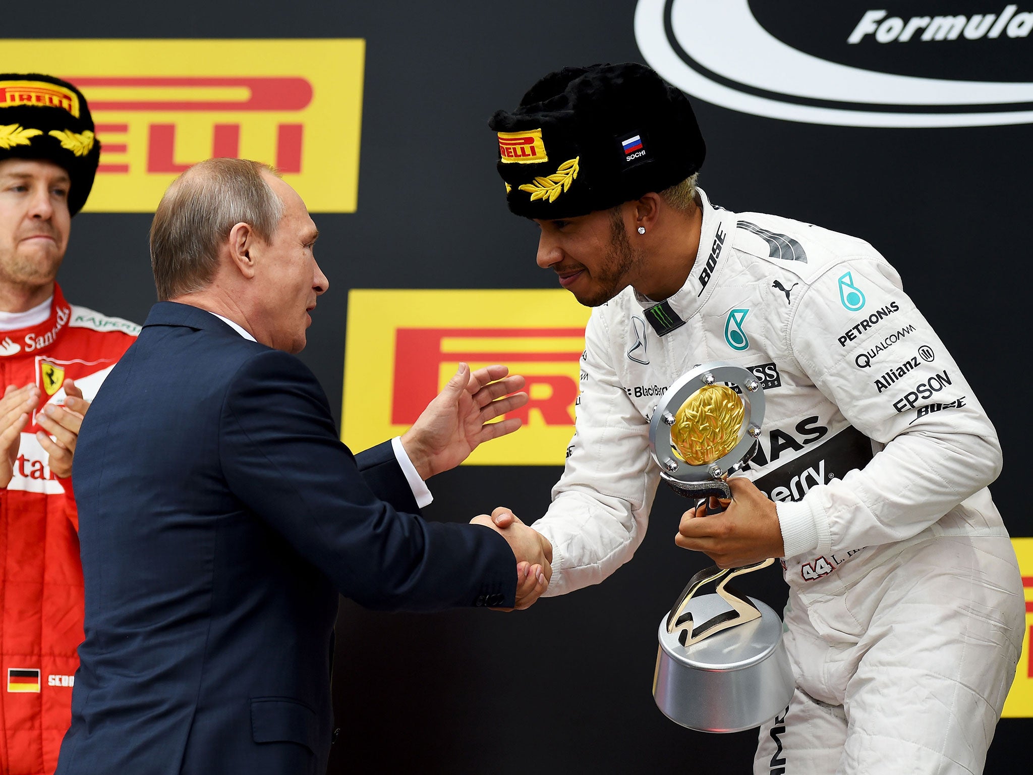 Vladimir Putin presents Lewis Hamilton with the winners' trophy after the Russian Grand Prix