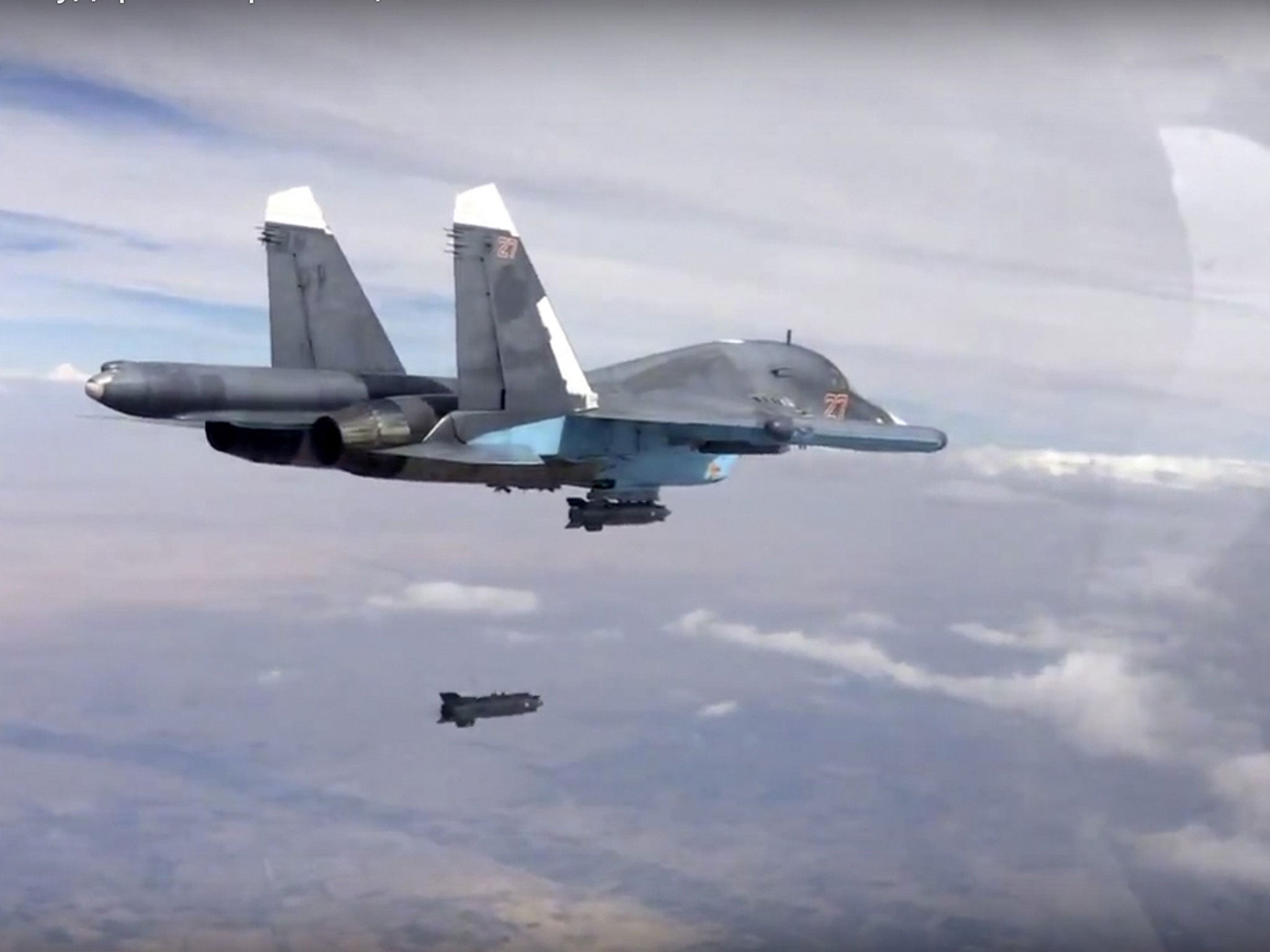 In this photo made from the footage taken from Russian Defense Ministry official web site on Friday, Oct. 9, 2015, a bomb is released from Russian Su-34 strike fighter in Syria