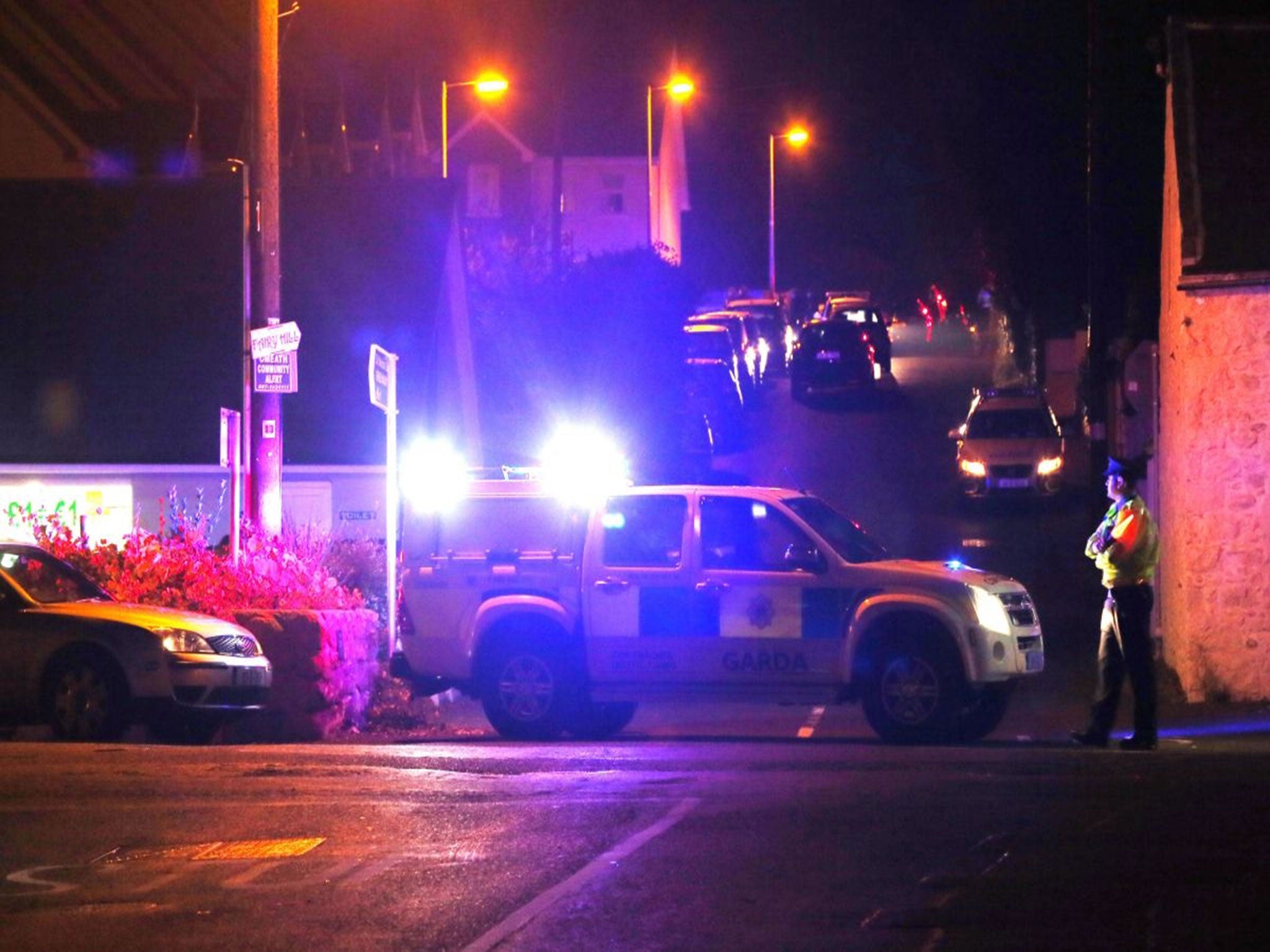 Police close off a road in Omeath, Co Louth after two men, one of whom was a garda in the Irish police force, were shot dead.