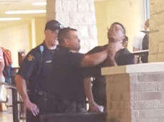 US police officer filmed grabbing teenager by the throat at school