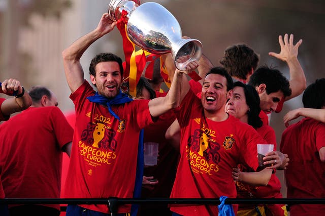 Spain's Juan Mata and Santi Cazorla lift the European Cup in 2012