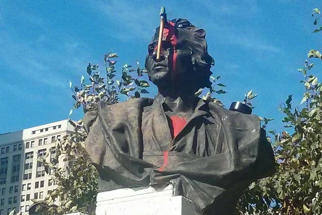 This Christopher Columbus statue has a new feature, a bloody hatchet to the forehead.