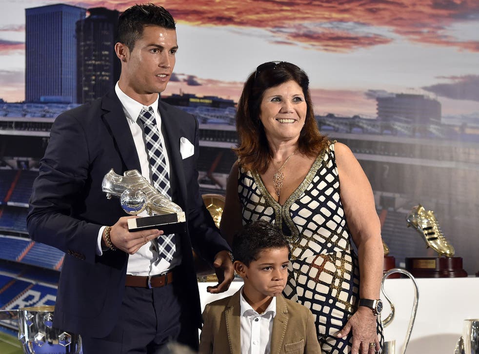 Real Madrid's forward Portuguese Cristiano Ronaldo (L) poses with his son Cristiano Jr and his mother Maria Dolores