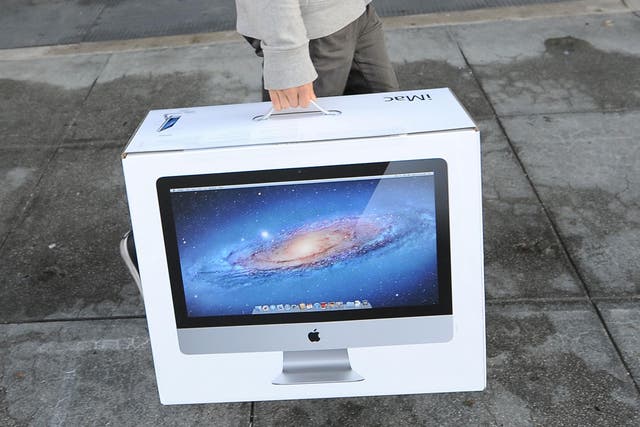 Jason Chen leaves the Apple store in Pasadena, California with a new iMac computer October 5, 2011