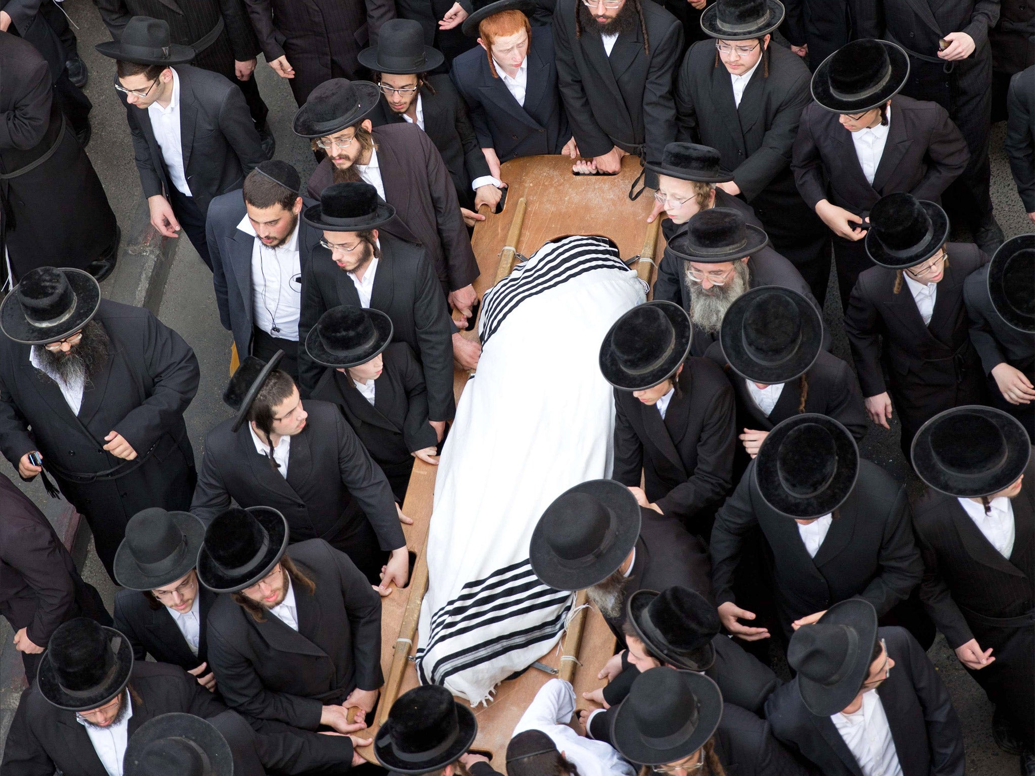 Utra-Othodox Jews attend the funeral of Yishaya Krashevsky. He was killed when a Palestinian drove a car into pedestrians