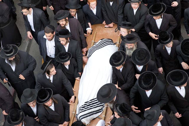 Utra-Othodox Jews attend the funeral of Yishaya Krashevsky. He was killed when a Palestinian drove a car into pedestrians