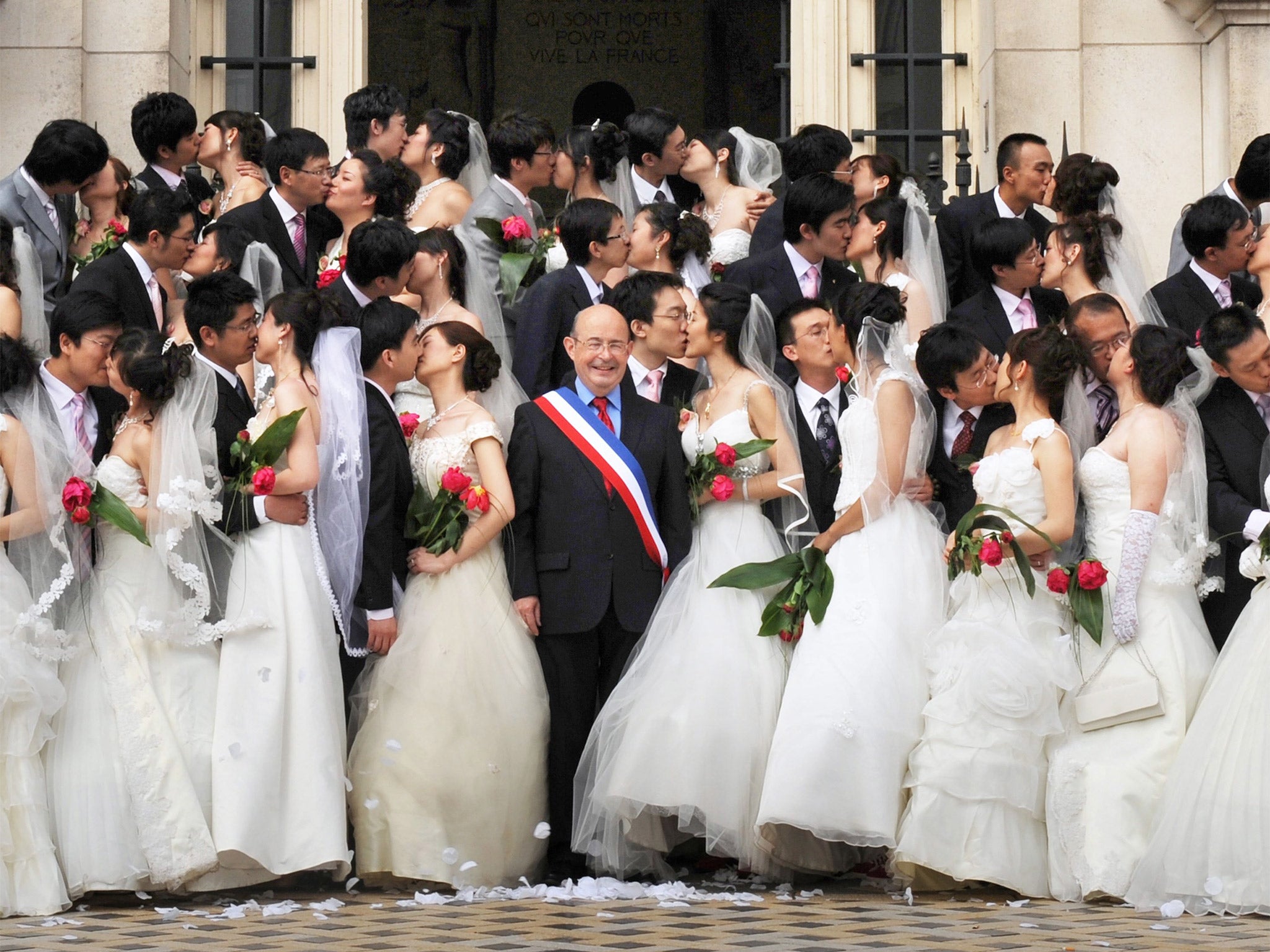 Recently married Chinese couples posing with the Mayor Jean Germain in Tours