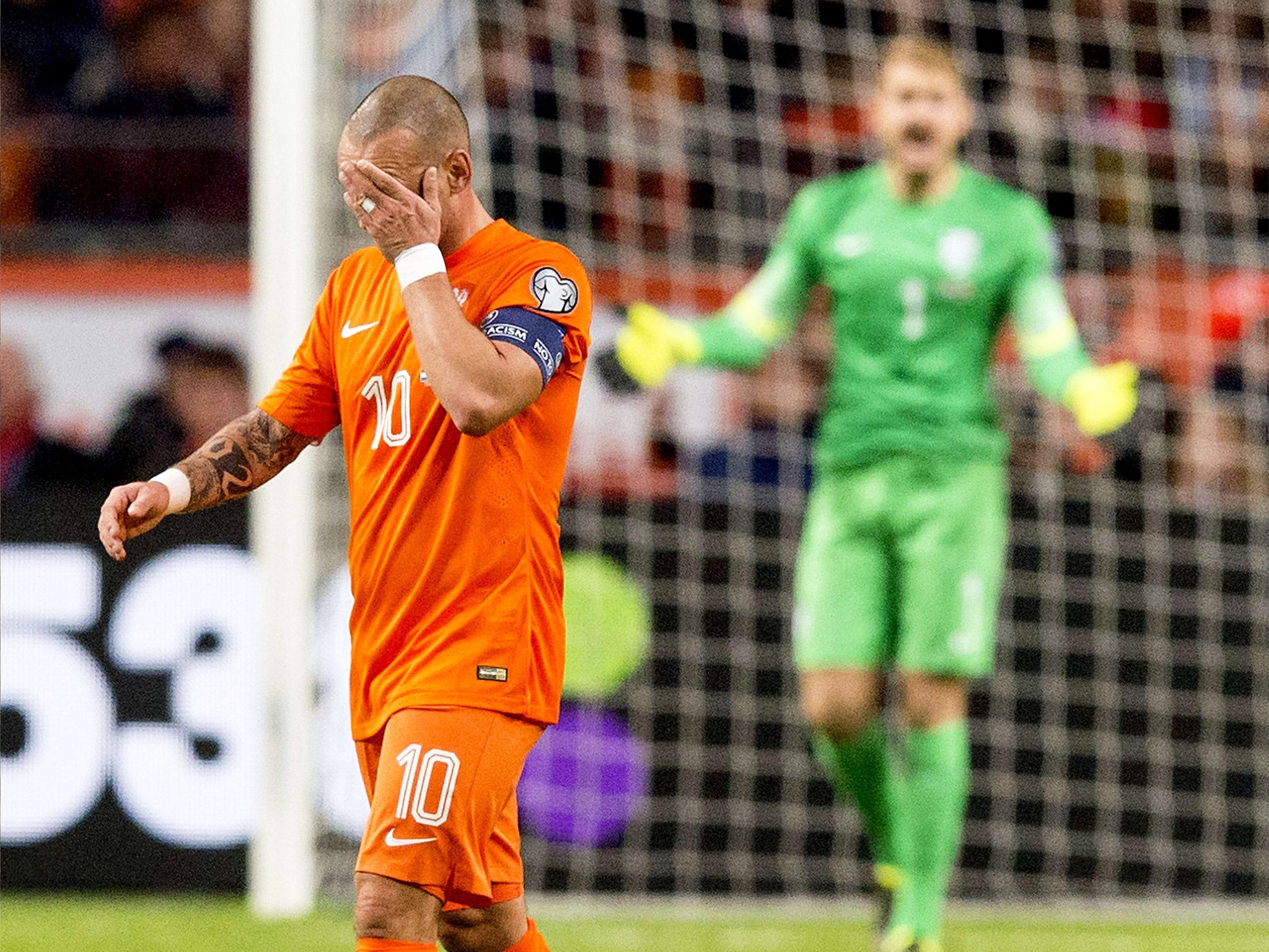 Wesley Sneijder, the Netherlands captain, reacts to one of the goals they conceded last night