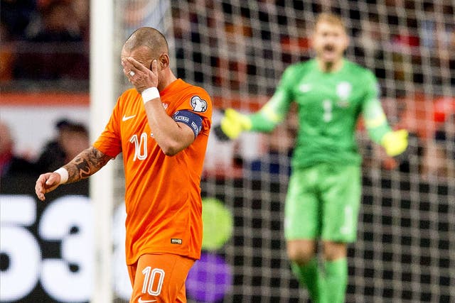 Wesley Sneijder, the Netherlands captain, reacts to one of the goals they conceded last night