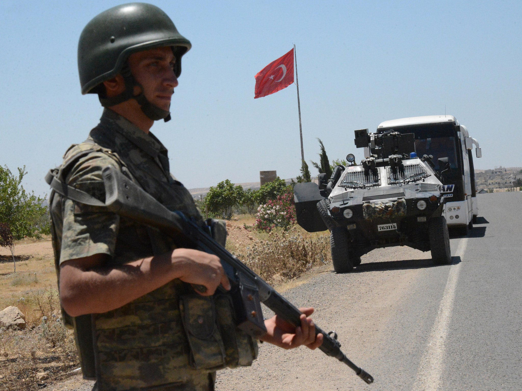 A Turkish soldier stands guard near the Syrian border. File photo