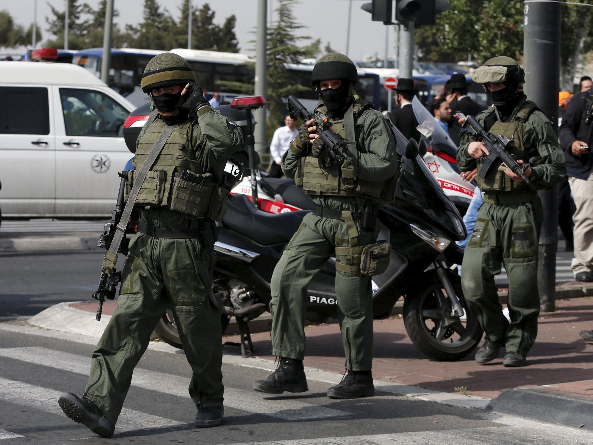 Israeli paramilitary police officers walk near the scene of a stabbing in Jerusalem October 12, 2015.