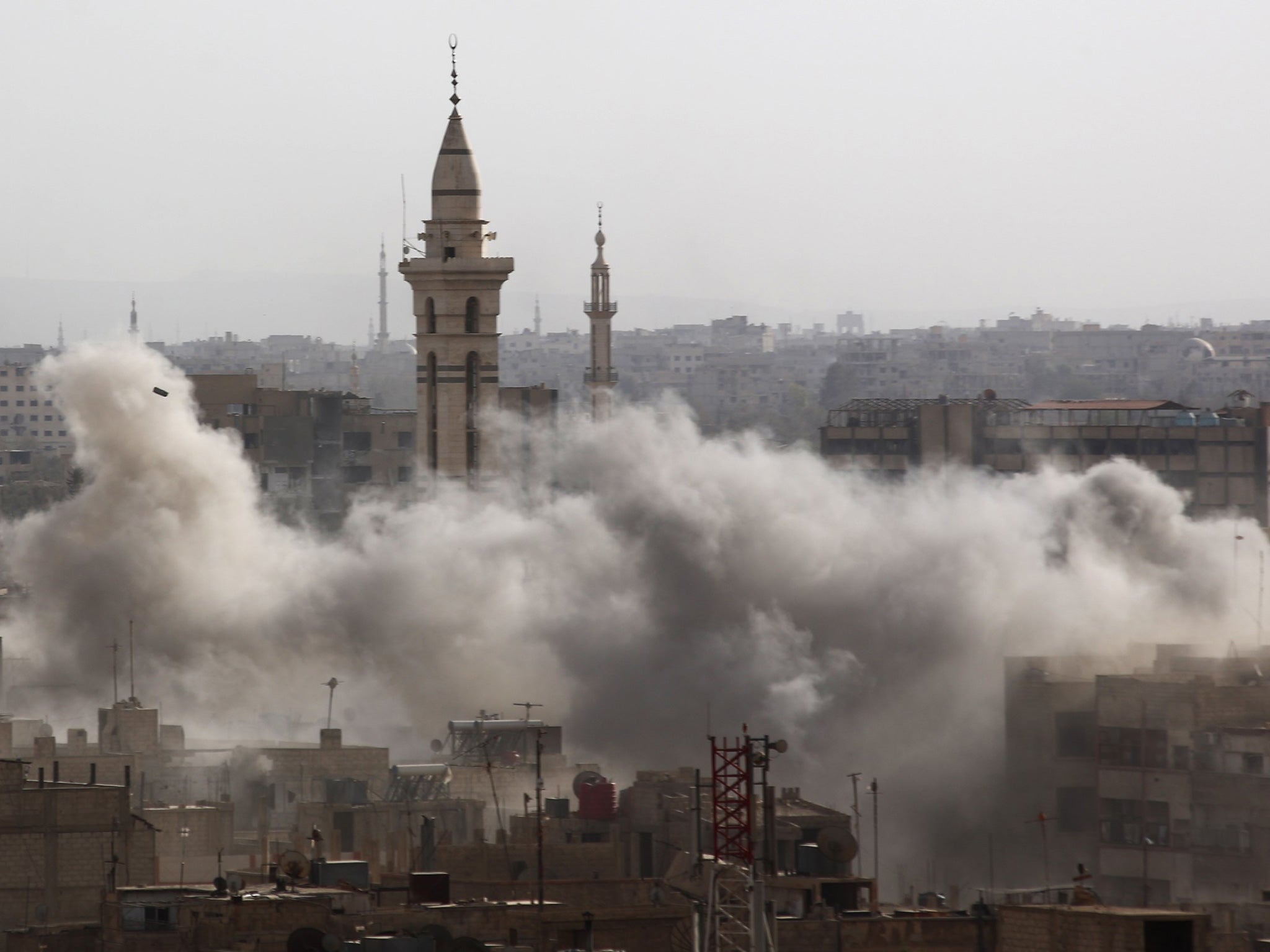 Smoke billows from the Syrian city of Douma following an air strike