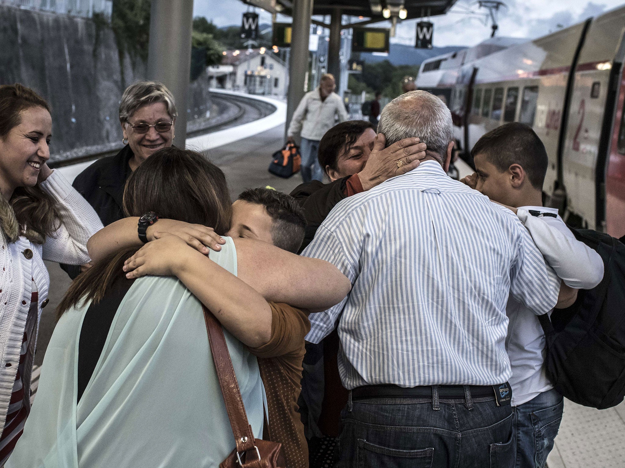 Iraqi refugees hug after arriving at Bellegarde-sur-Valserine railway station in western France, in September.