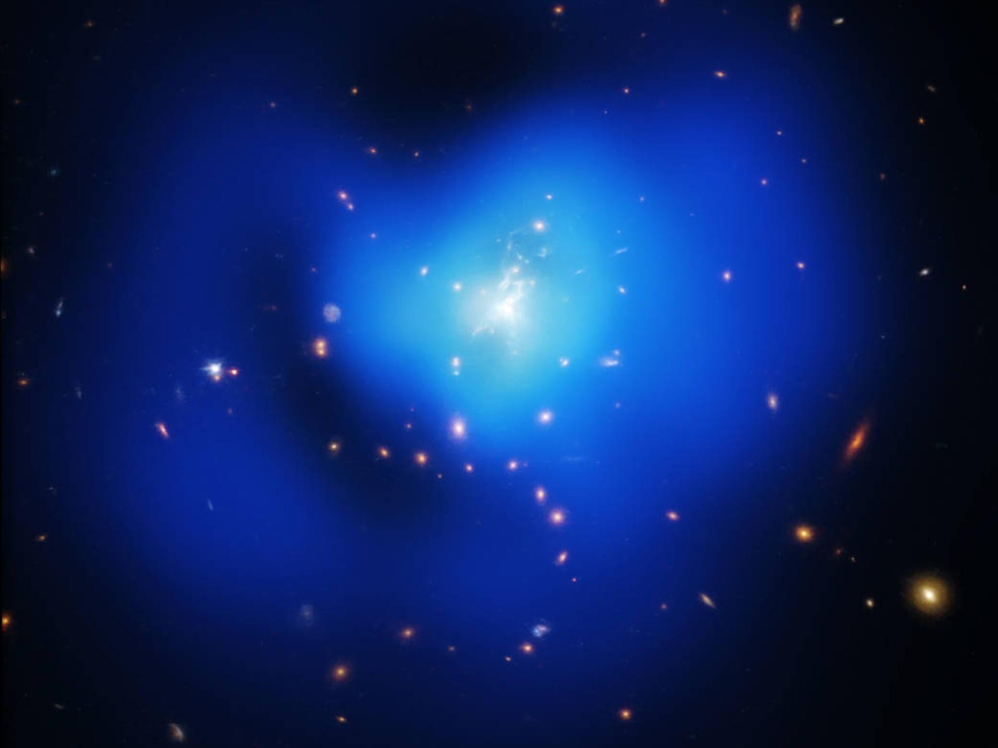 A galaxy cluster, like this one, is thought to contain vast amounts of dark matter that cannot be seen but has a gravitational effect