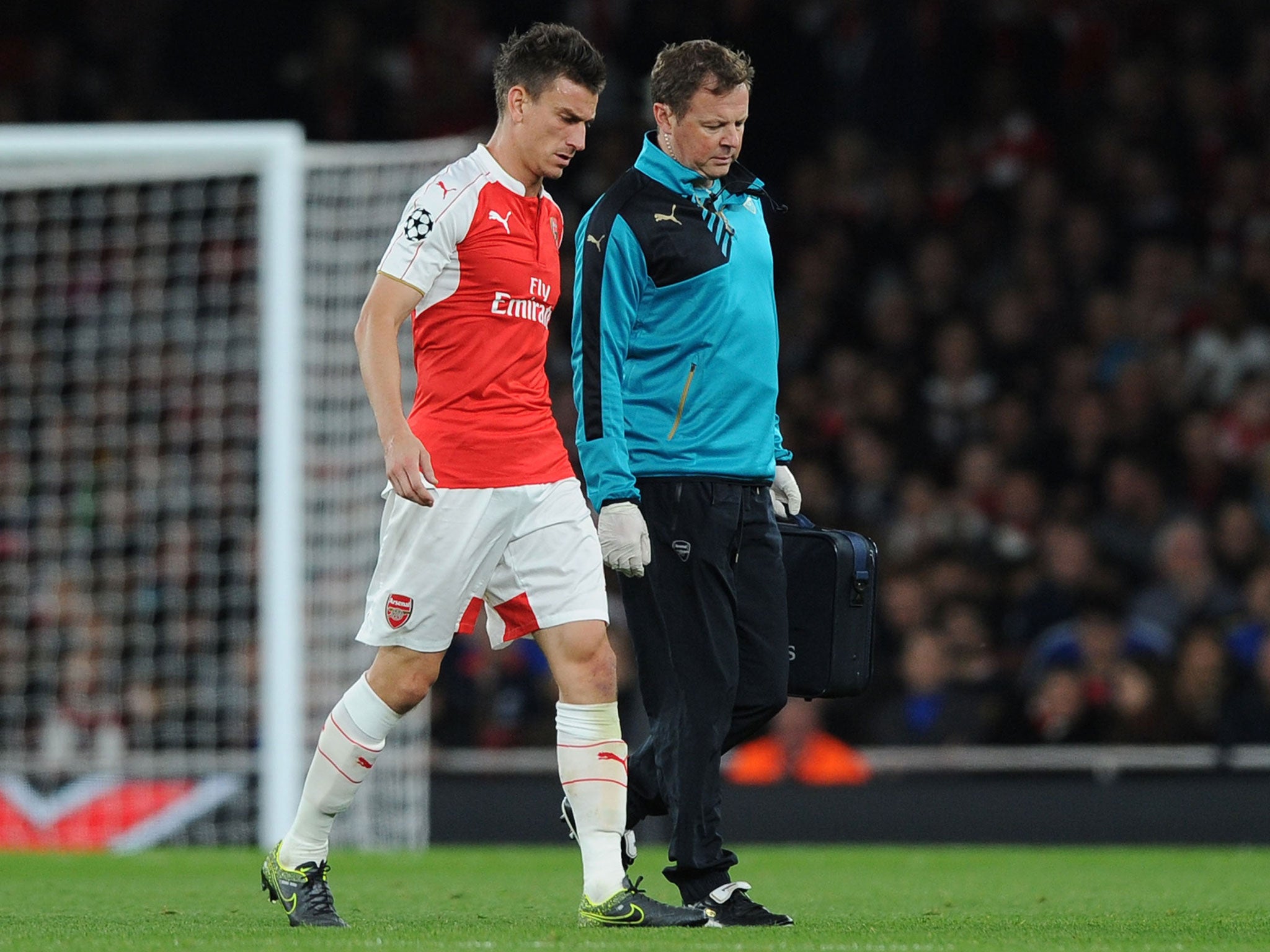 Laurent Koscielny limps off during Arsenal's defeat to Olympiakos