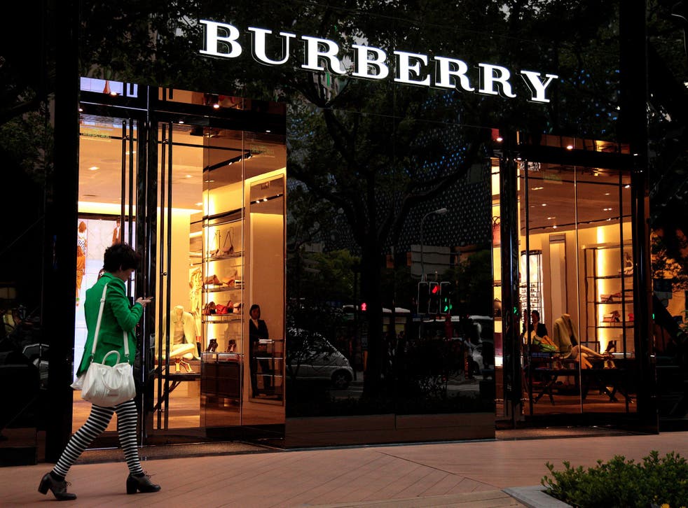 A woman walks in front of Burberry's new flagship store  in Shanghai, China.
