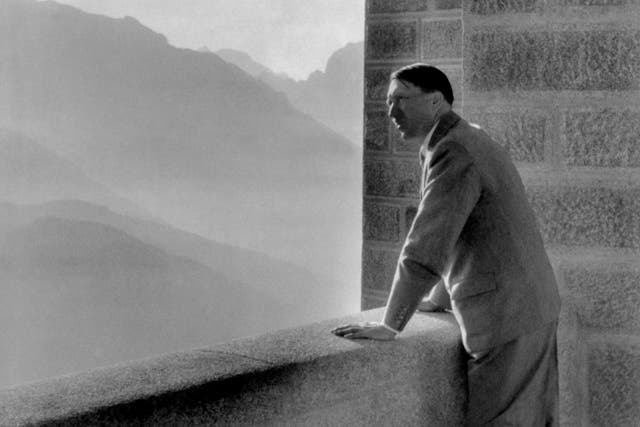 A picture dated 1938 shows German nazi Chancellor Adolf Hitler looking at the Obersalzberg Mountains from a balcony of his Berghof residence near Berchtesgaden
