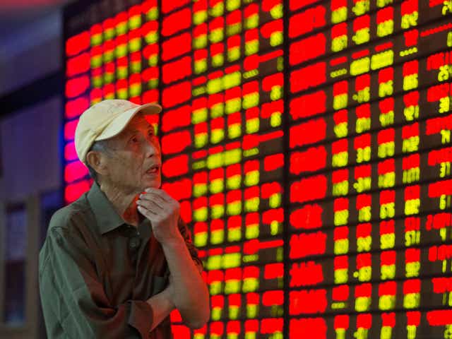 An investor observes the stock market at a stock exchange hall in Nanjing, China, last year