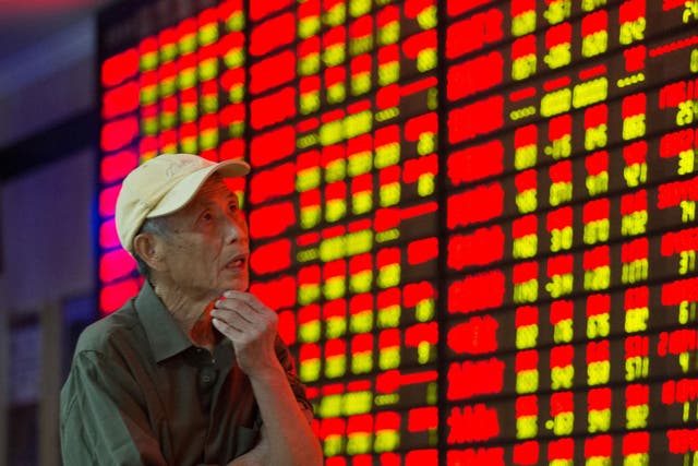 An investor observes the stock market at a stock exchange hall in Nanjing, China, last year