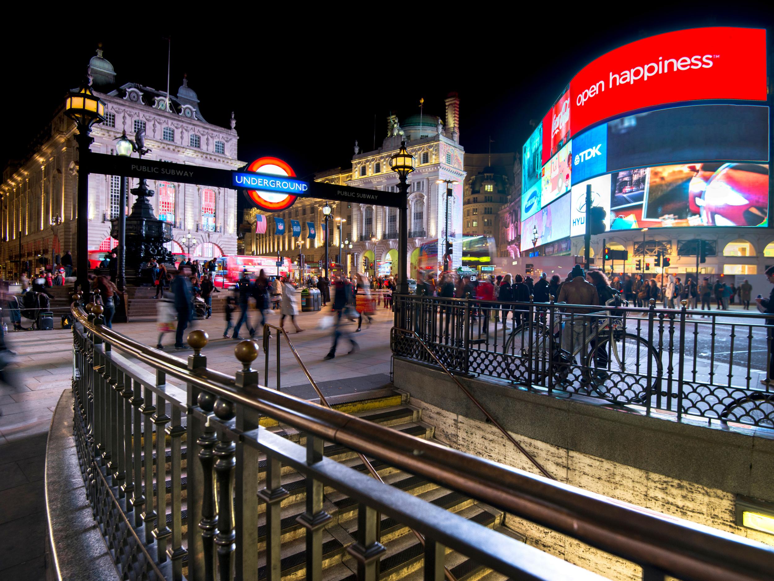 Long exposure of pedestrians and traffic outside Piccadilly Circus tube station in London