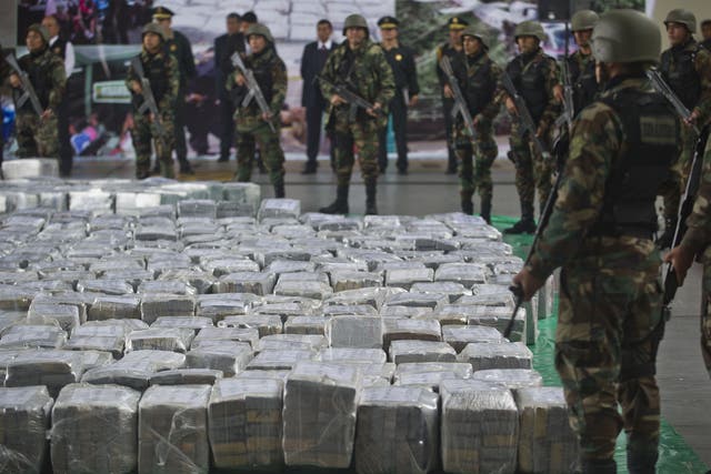 Police officers stand guard over a 7-tonne haul of cocaine seized at the Jorge Chávez International Airport in Lima in 2014