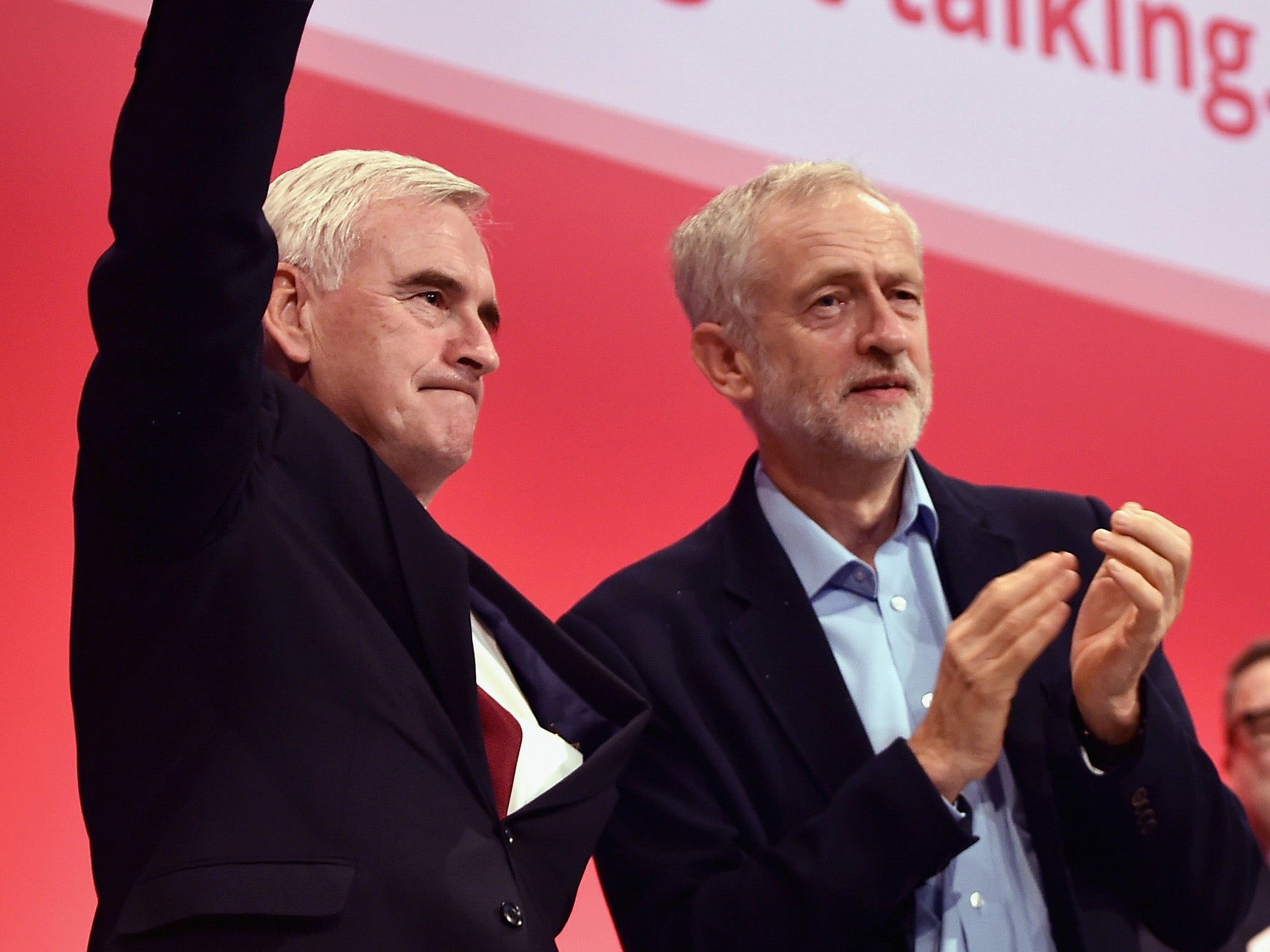 Shadow chancellor John McDonnell and Jeremy Corbyn take applause after addressing the Labour Party autumn conference