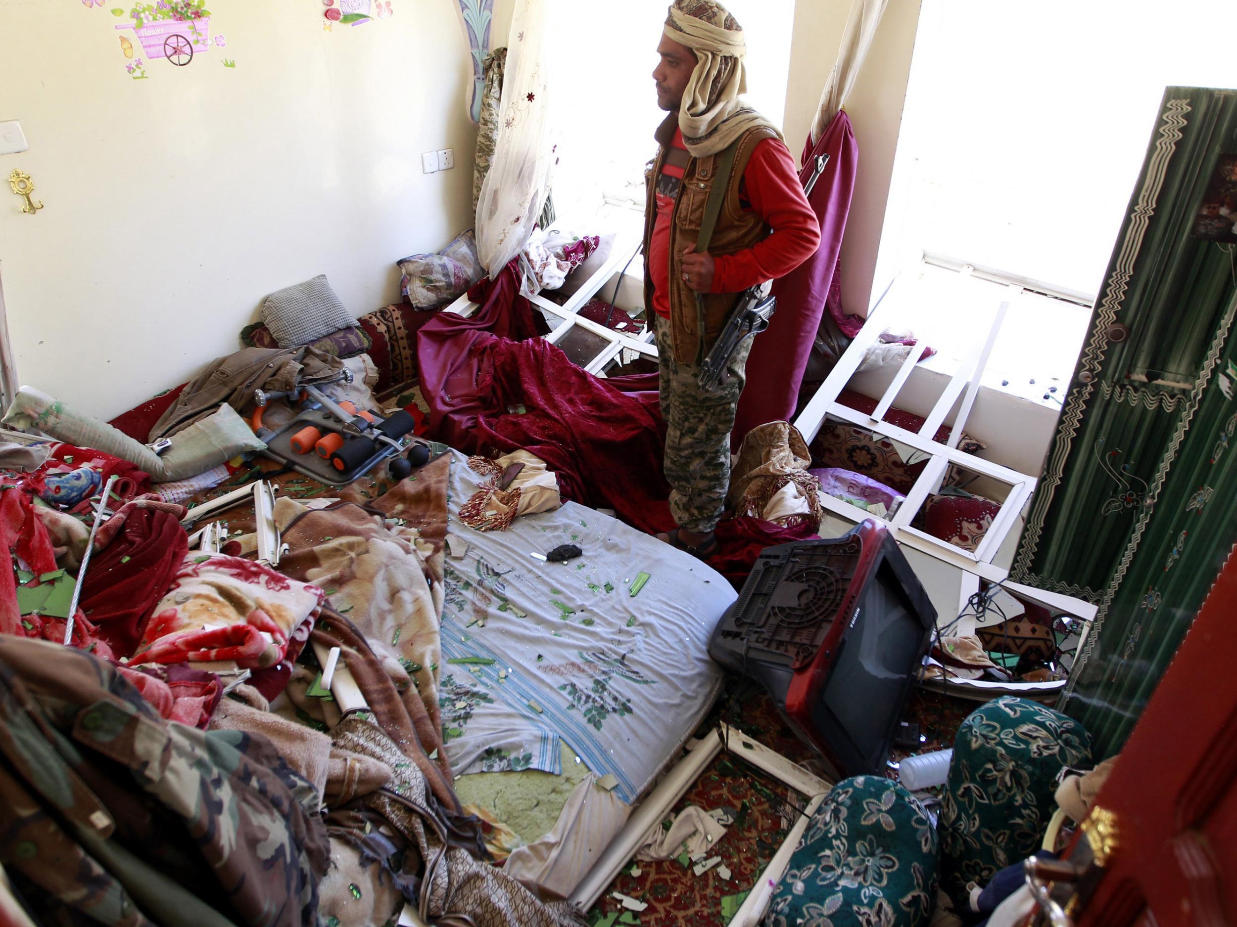 A Yemeni man inspects the damage in his house following air strikes carried out by the Saudi-led coalition in the capital Sanaa.