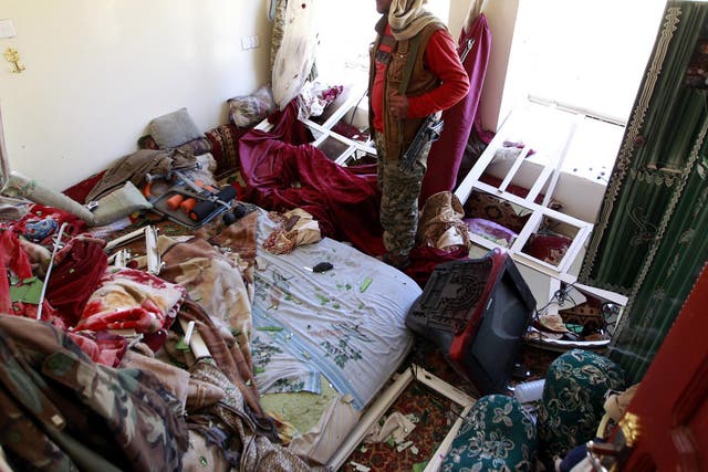 A Yemeni man inspects the damage in his house following air strikes carried out by the Saudi-led coalition in the capital Sanaa.