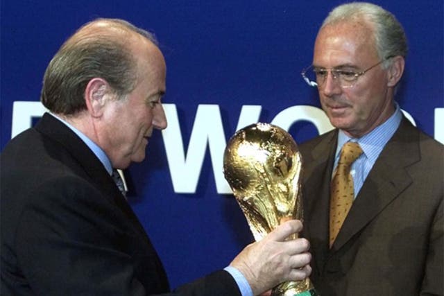 Sepp Blatter with Franz Beckenbauer right, July 2000 handing over a copy of the World Cup trophy