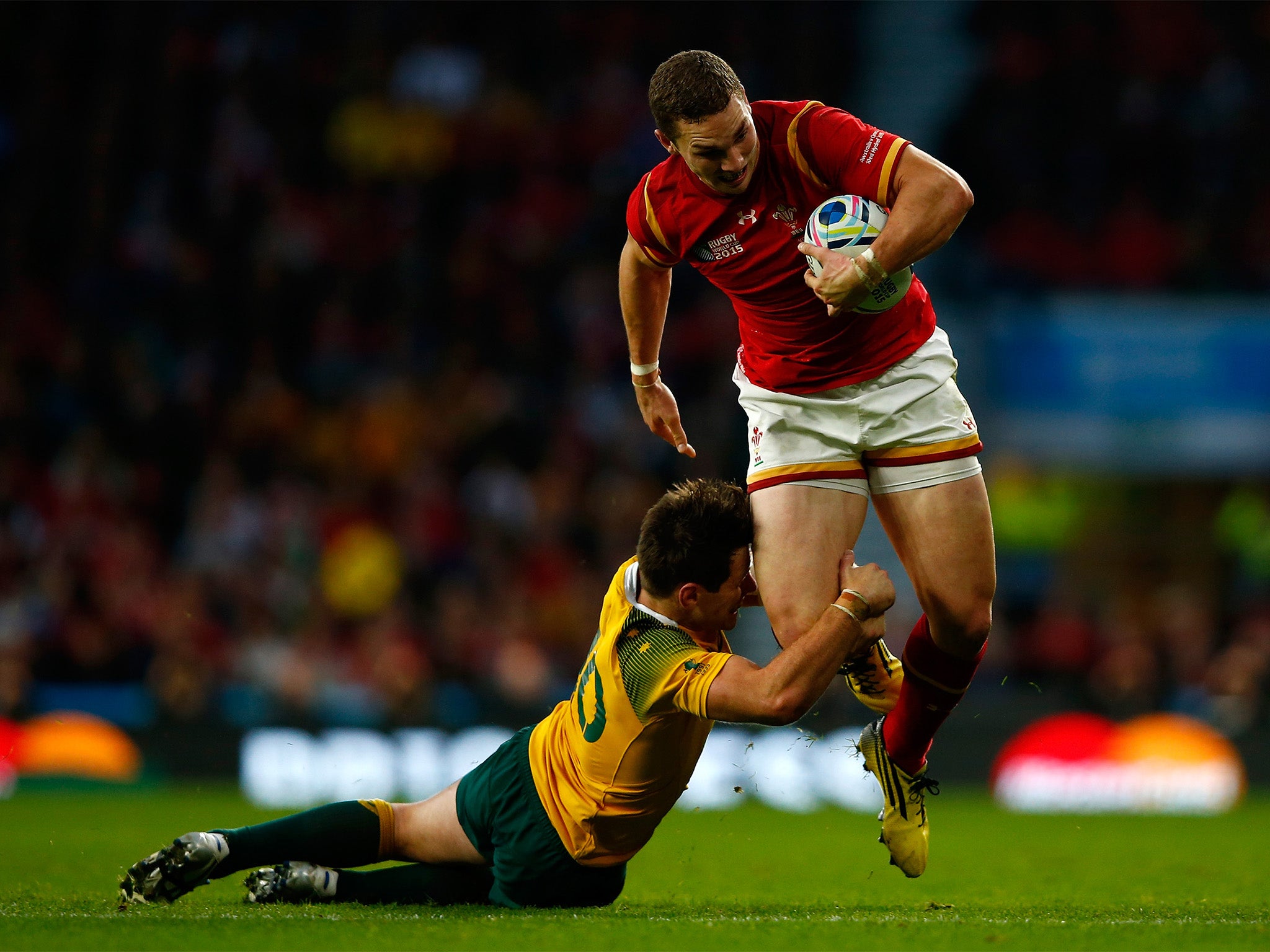 George North of Wales is tackled by Bernard Foley of Australia during the 2015 Rugby World Cup Pool A match between Australia and Wales at Twickenham Stadium on