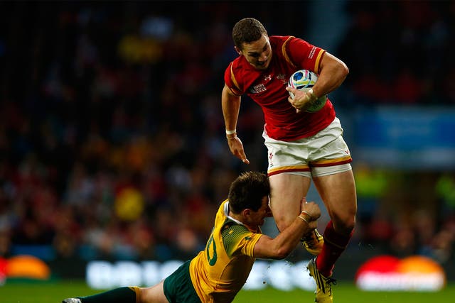 George North of Wales is tackled by Bernard Foley of Australia during the 2015 Rugby World Cup Pool A match between Australia and Wales at Twickenham Stadium on