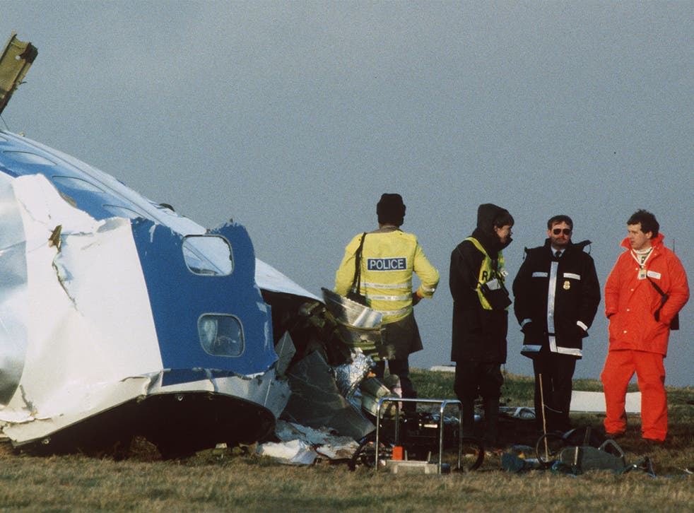 Scottish rescue workers and crash investigators search the area following the bombing of Pan Am flight 103 over Lockerbie in Scotland