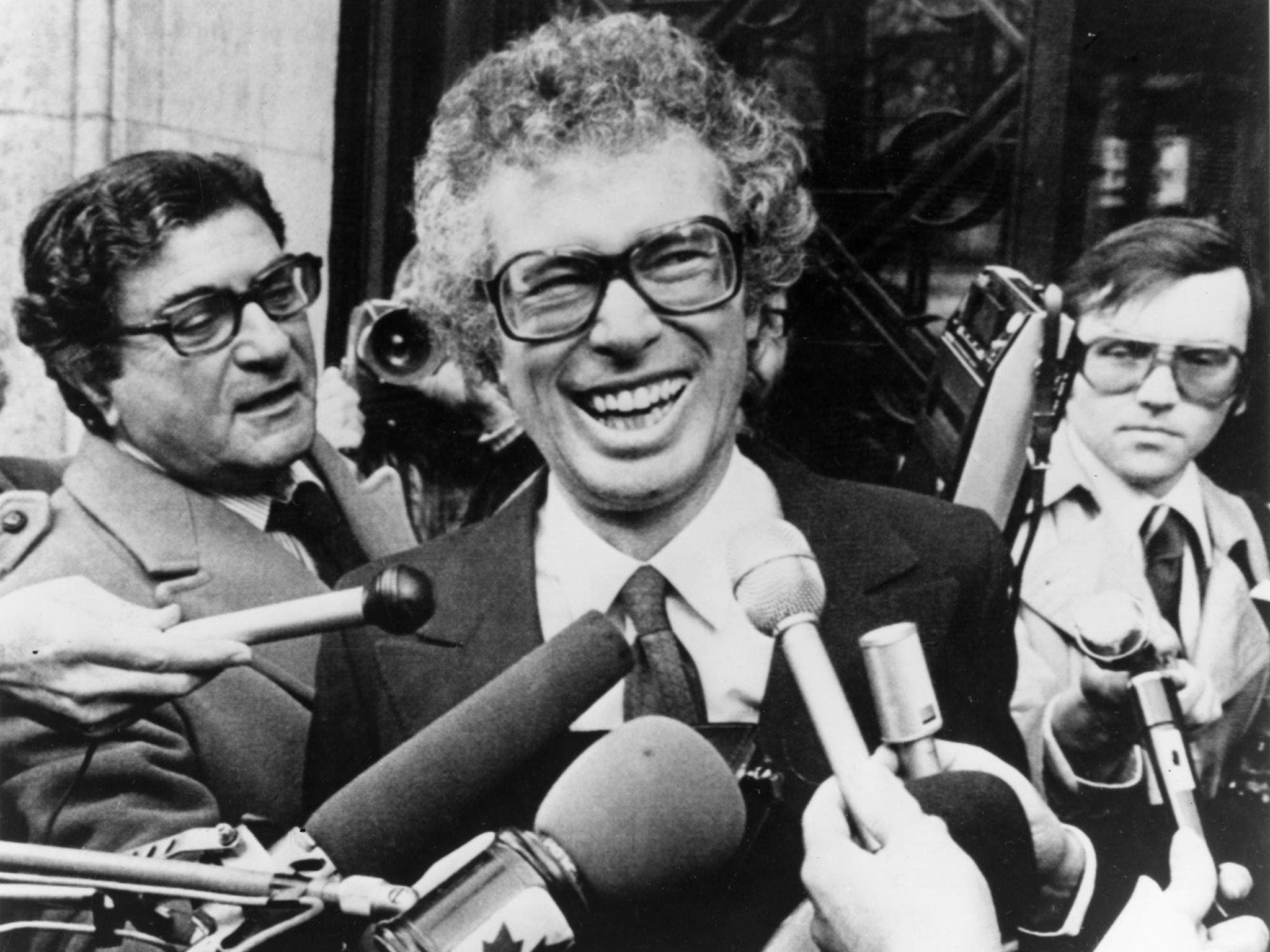 FILE - In this Jan. 31, 1980, file photo, Ken Taylor, Canadian Ambassador to Iran, laughs as he answers questions during a meeting with journalists outside the Canadian Embassy in Paris