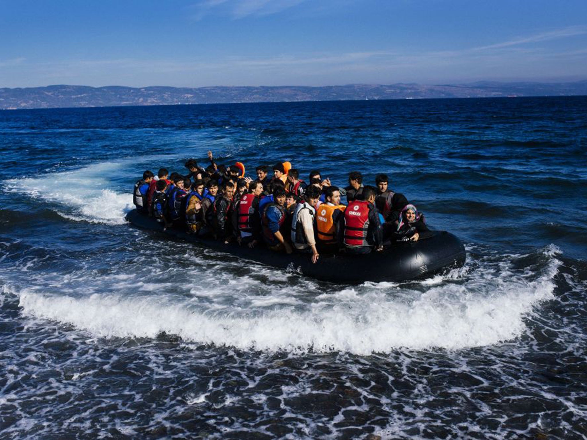 A boat arrives on Lesbos, after crossing the Aegean from the Turkish coast