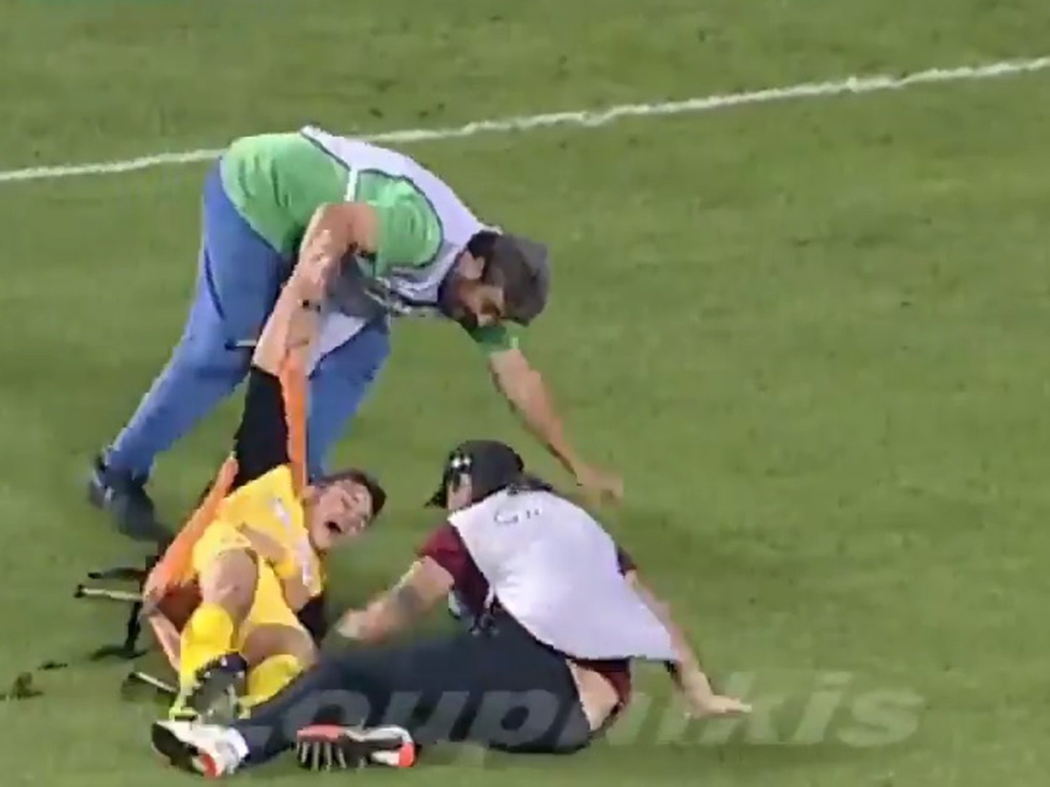 The medics fail miserably to carry the player off the pitch