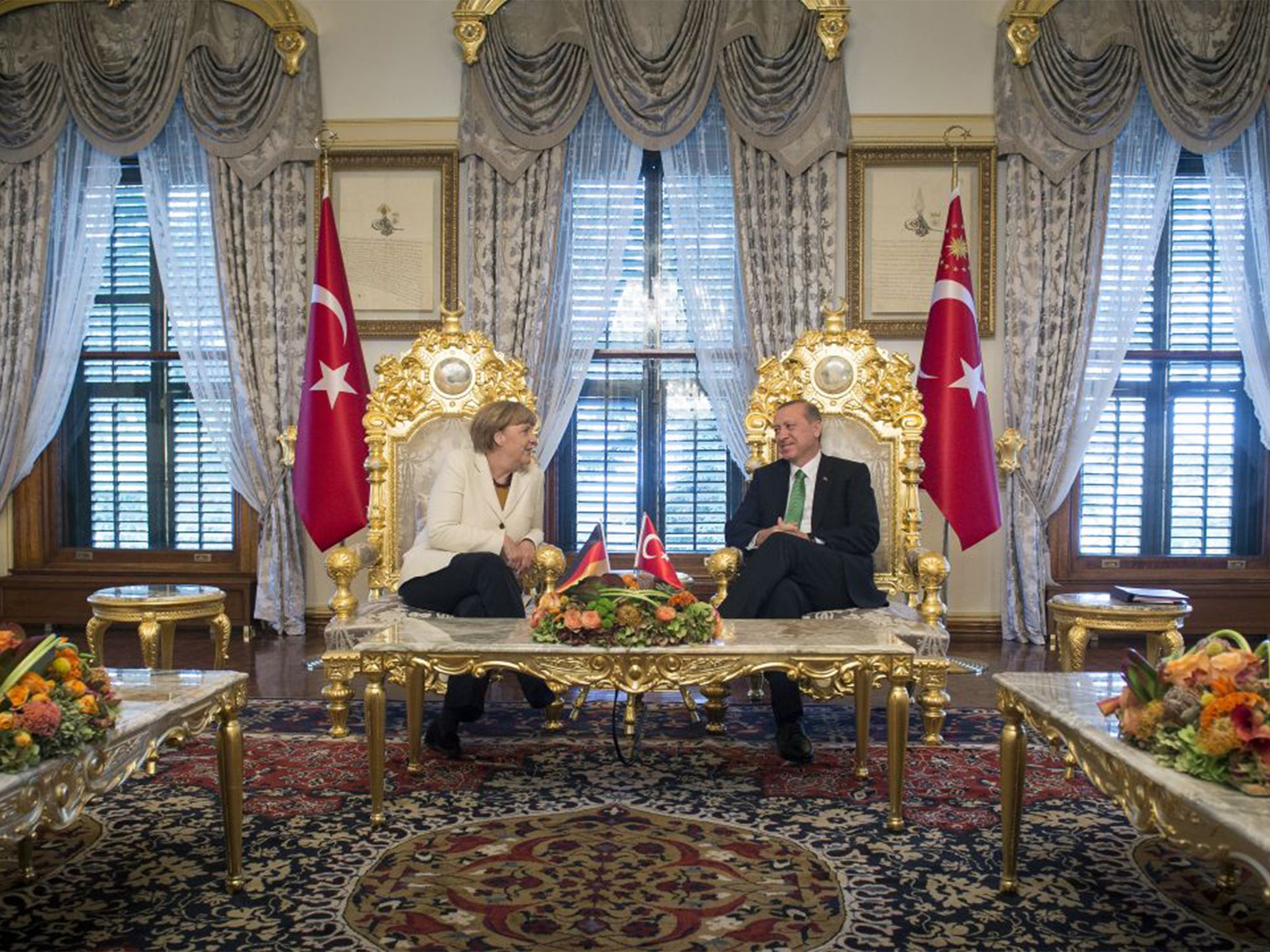 German Chancellor Angela Merkel and Turkish President Recep Tayyip Erdogan talk at the start of their meeting at the Yildiz Palace