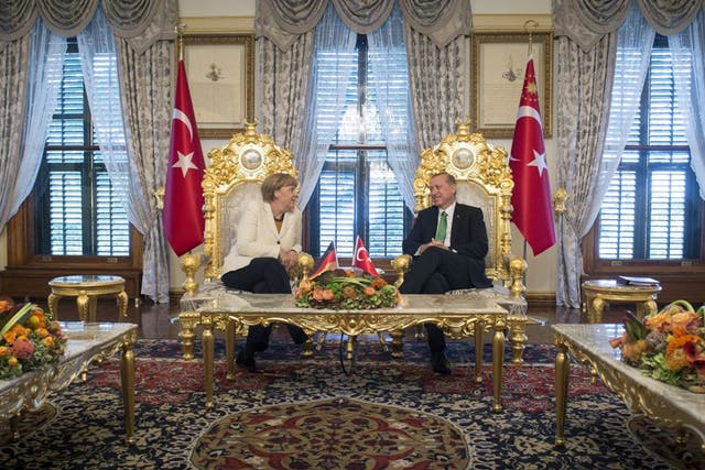 German Chancellor Angela Merkel and Turkish President Recep Tayyip Erdogan talk at the start of their meeting at the Yildiz Palace