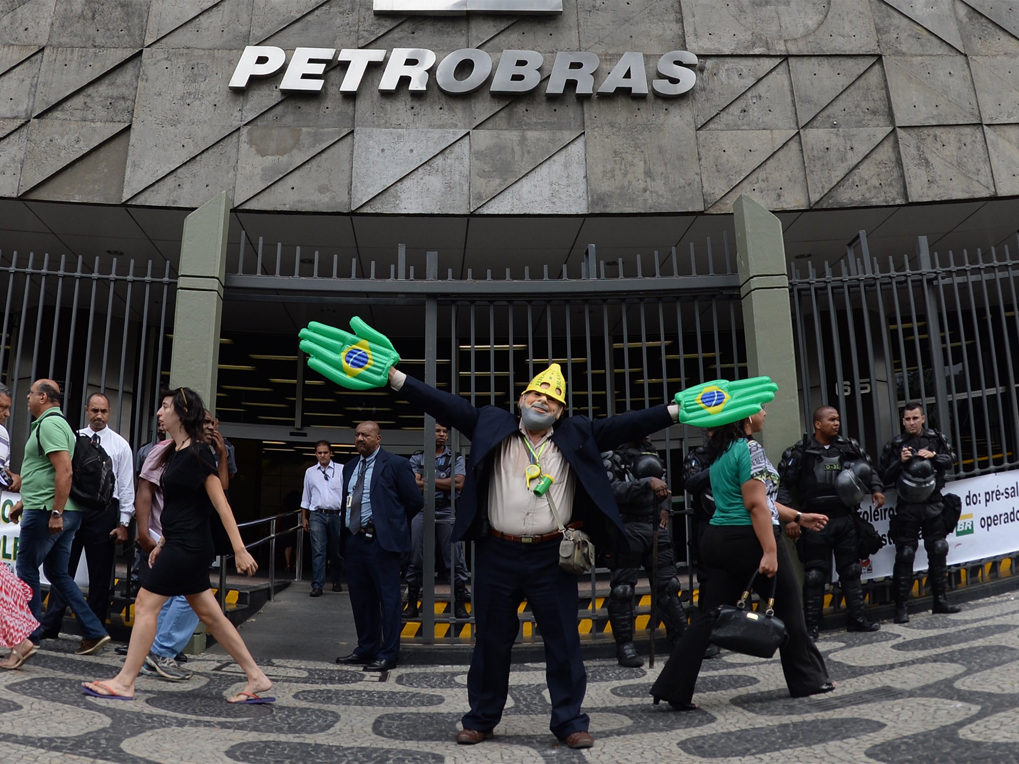 A protester  impersonating Brazilian former president Luiz Inacio Lula da Silva outside of the pentrobras headquarters in Brazil