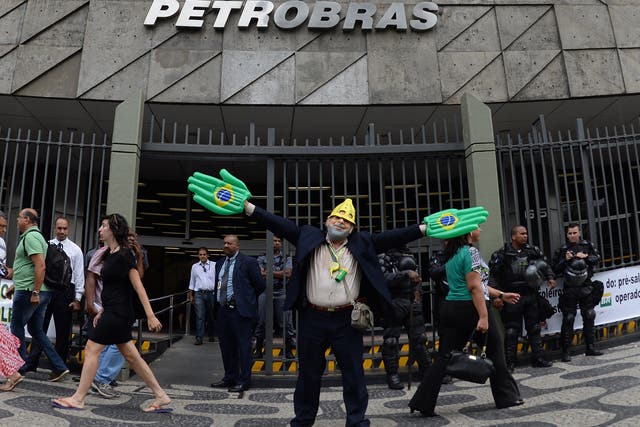 A protester  impersonating Brazilian former president Luiz Inacio Lula da Silva outside of the pentrobras headquarters in Brazil