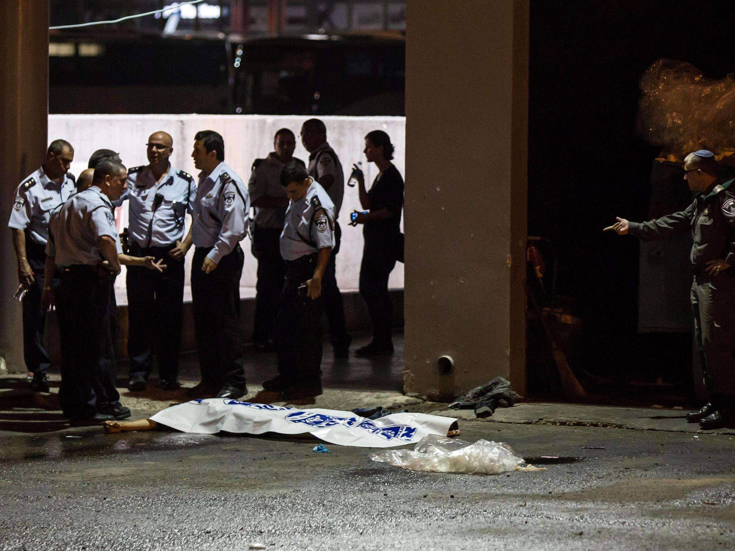 Israeli police stand by the body of attacker in Beersheba, Israel