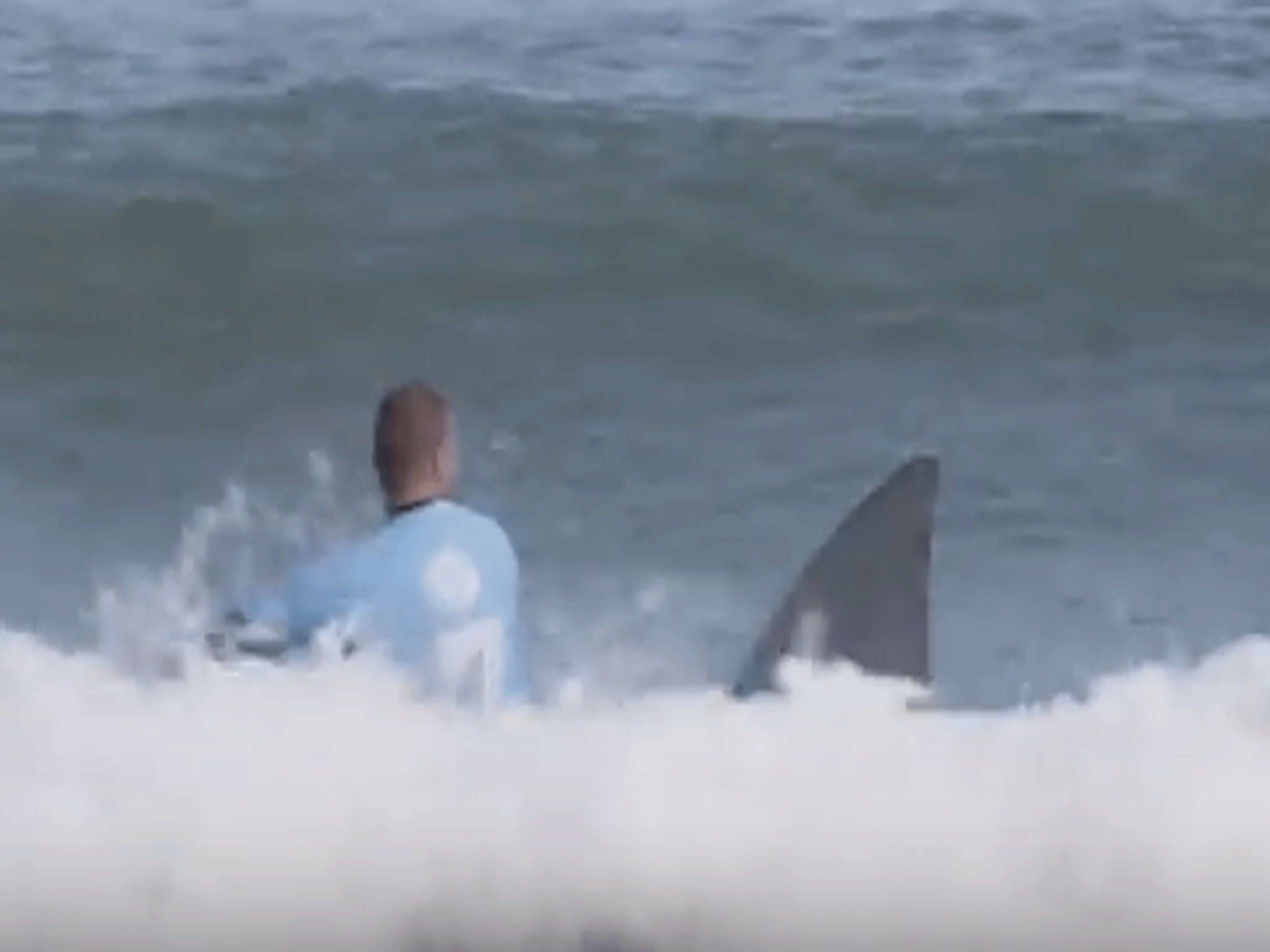 The advert begins with a close-up shot of a Mike Fanning lookalike in the sea, suddenly approached by a shark fin before momentarily disappearing behind a wave